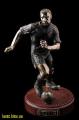 bronze sculpture of a football player, a bronze statuette poker star