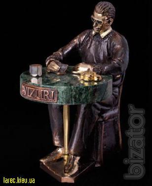 bronze sculpture of a football player, a bronze statuette poker star 