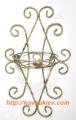 Wrought iron flower stands suspended. 
