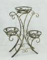 Wrought iron flower stands suspended. 