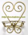 Wrought iron flower stands suspended.