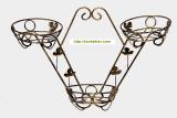 Wrought iron flower stands suspended. 