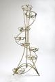 Wrought iron flower stands suspended. 