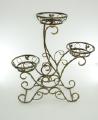 Wrought iron flower stands suspended. 