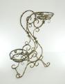 Wrought iron flower stands suspended. 