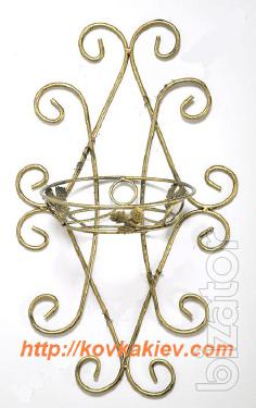 Wrought iron flower stands suspended. 