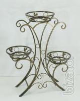 Wrought iron flower stands suspended. 