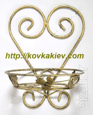 Wrought iron flower stands suspended. 