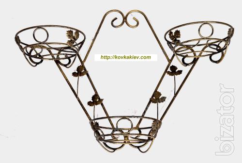 Wrought iron flower stands suspended. 