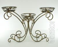 Wrought iron flower stands suspended. 
