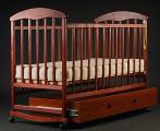 Cot "Natalka" in a dark tone with drawer.