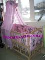 A set of clothes in the crib with canopy and protection 