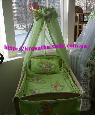 A set of clothes in the crib with canopy and protection 