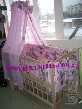 A set of clothes in the crib with canopy and protection 